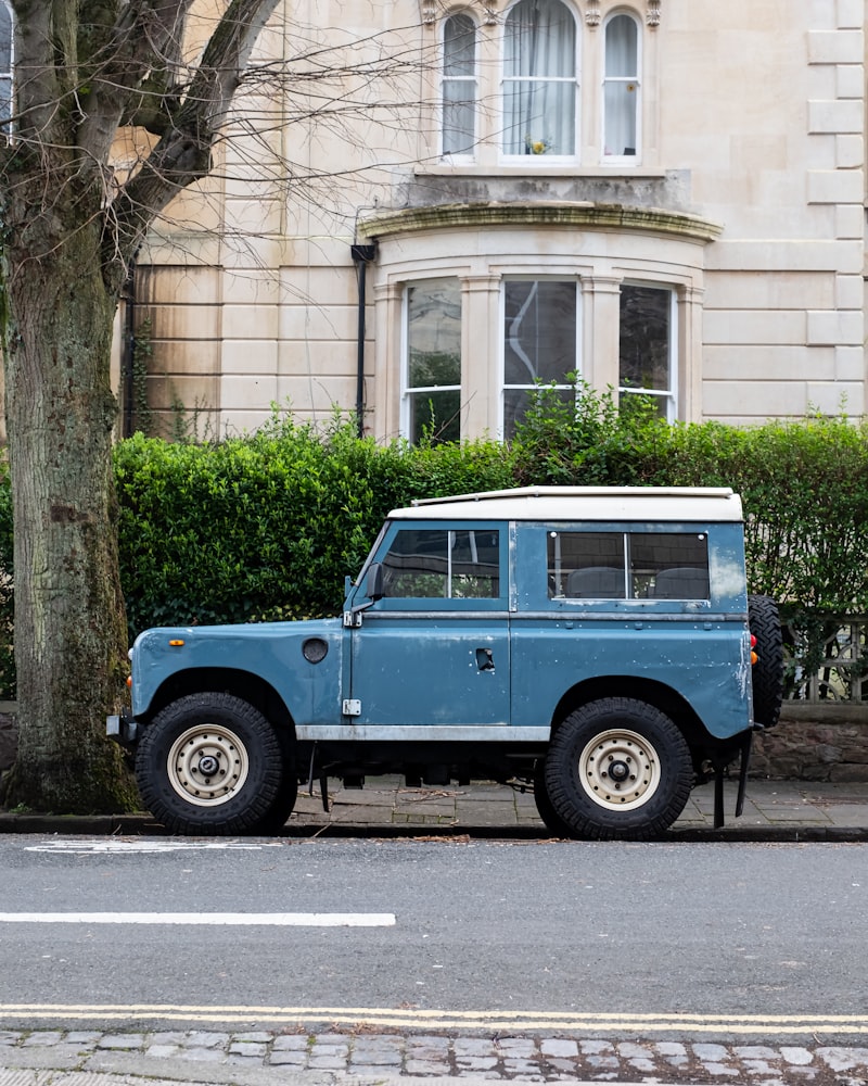 Classic Land Rover Series vehicle in blue and white, showcasing the utilitarian design