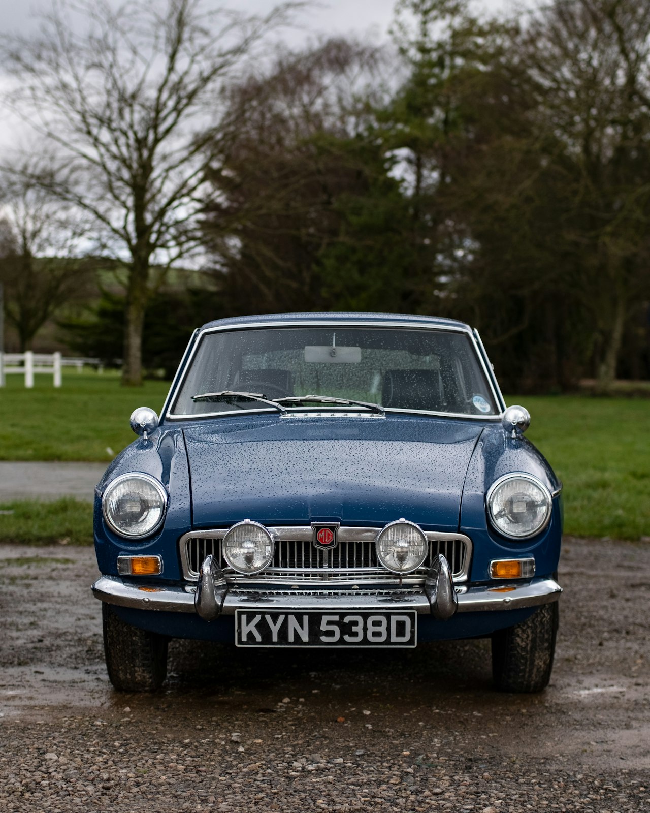 Classic blue MG sports car parked in the British countryside, Somerset