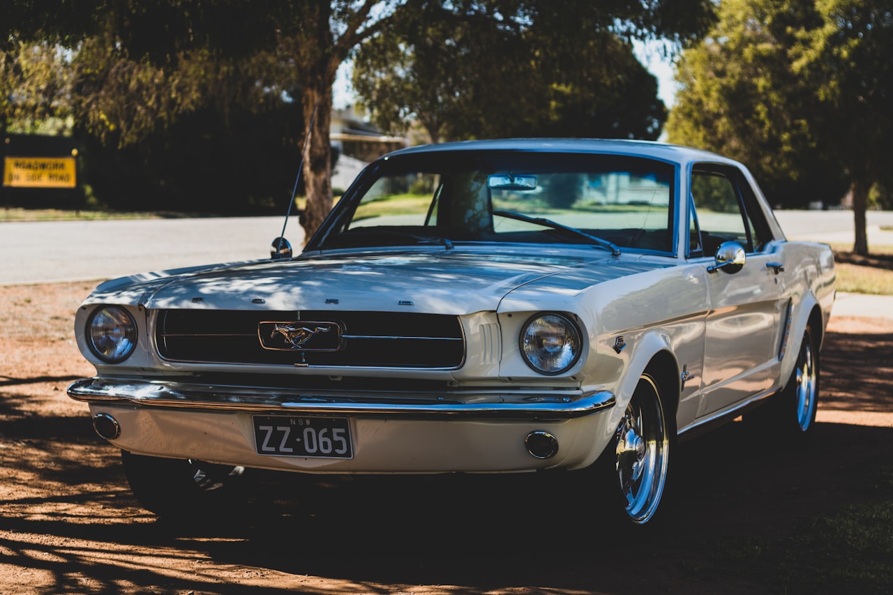 1965 Ford Mustang coupe in white, showcasing classic first-generation pony car styling