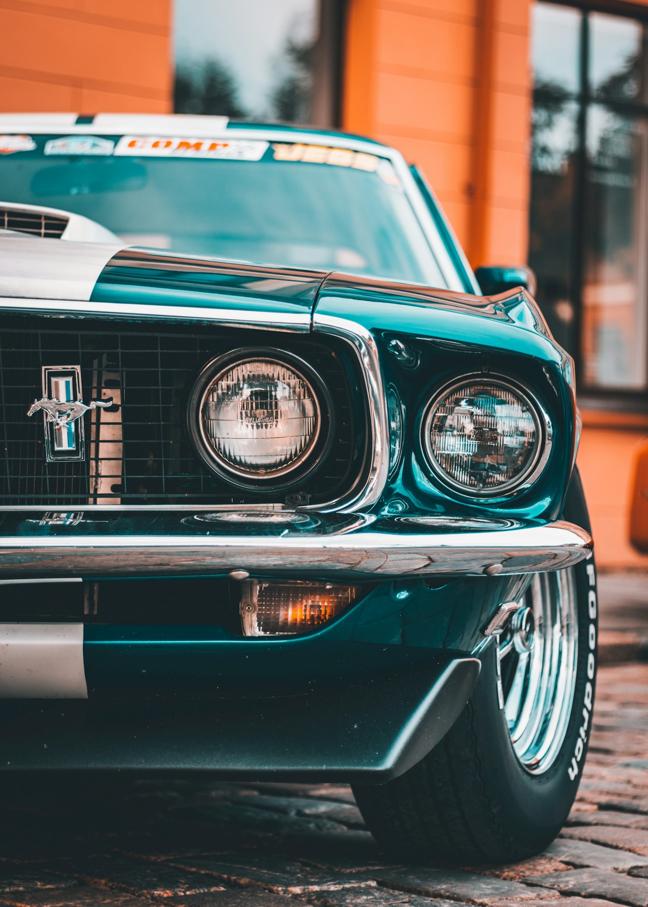 Classic green Ford Mustang front view, showing the distinctive grille and long bonnet