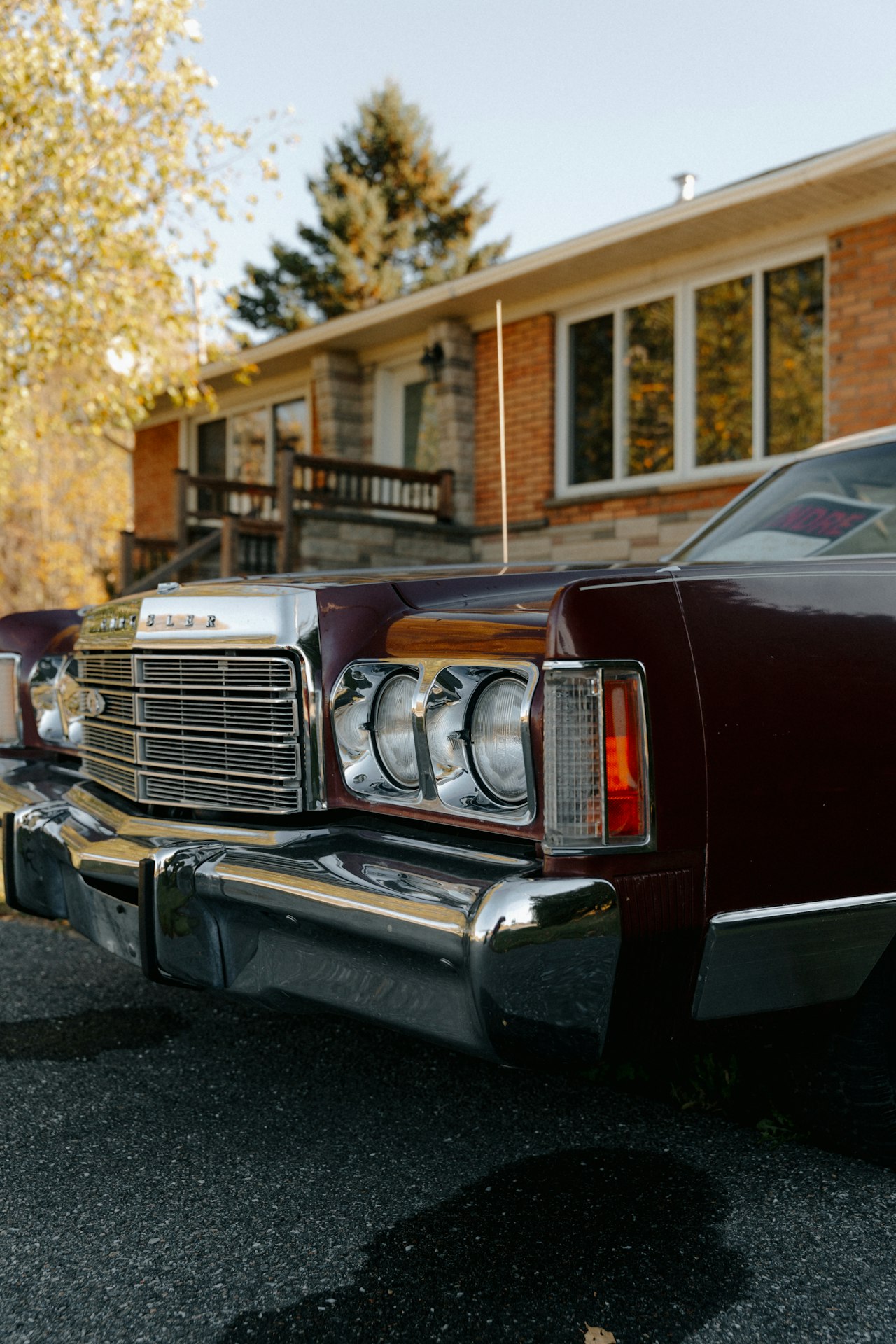 Maroon vintage car with original period-correct parts and chrome trim