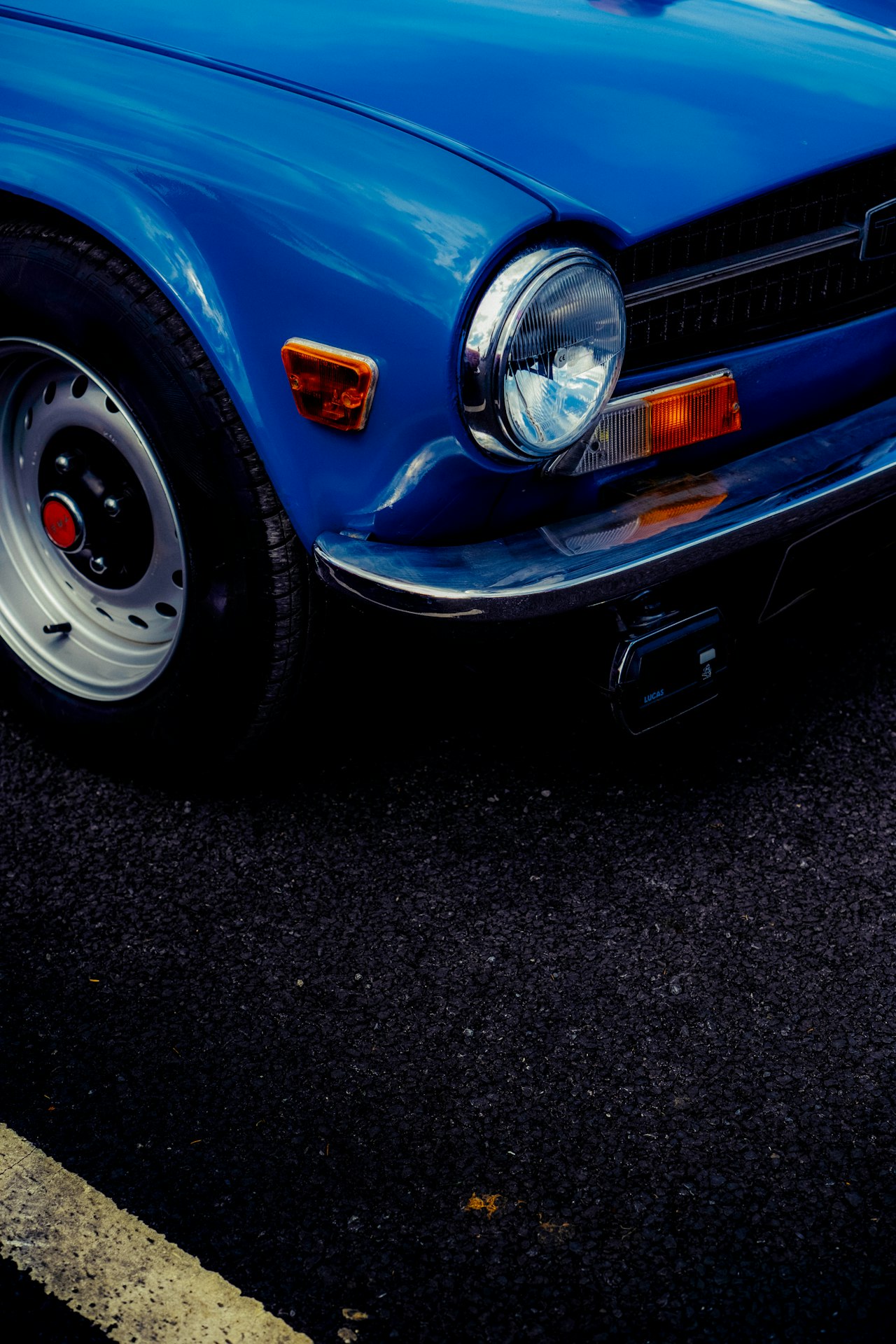 Blue vintage car showing classic suspension and steering components