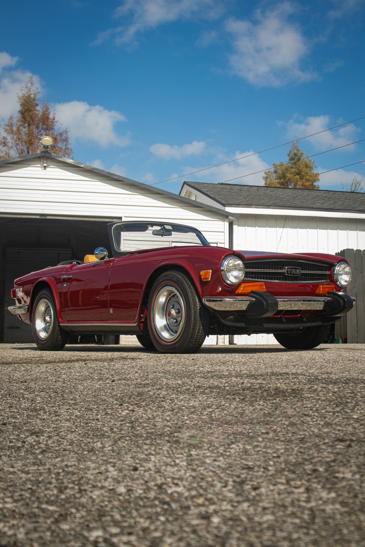 Red Triumph TR6 convertible, rear three-quarter view