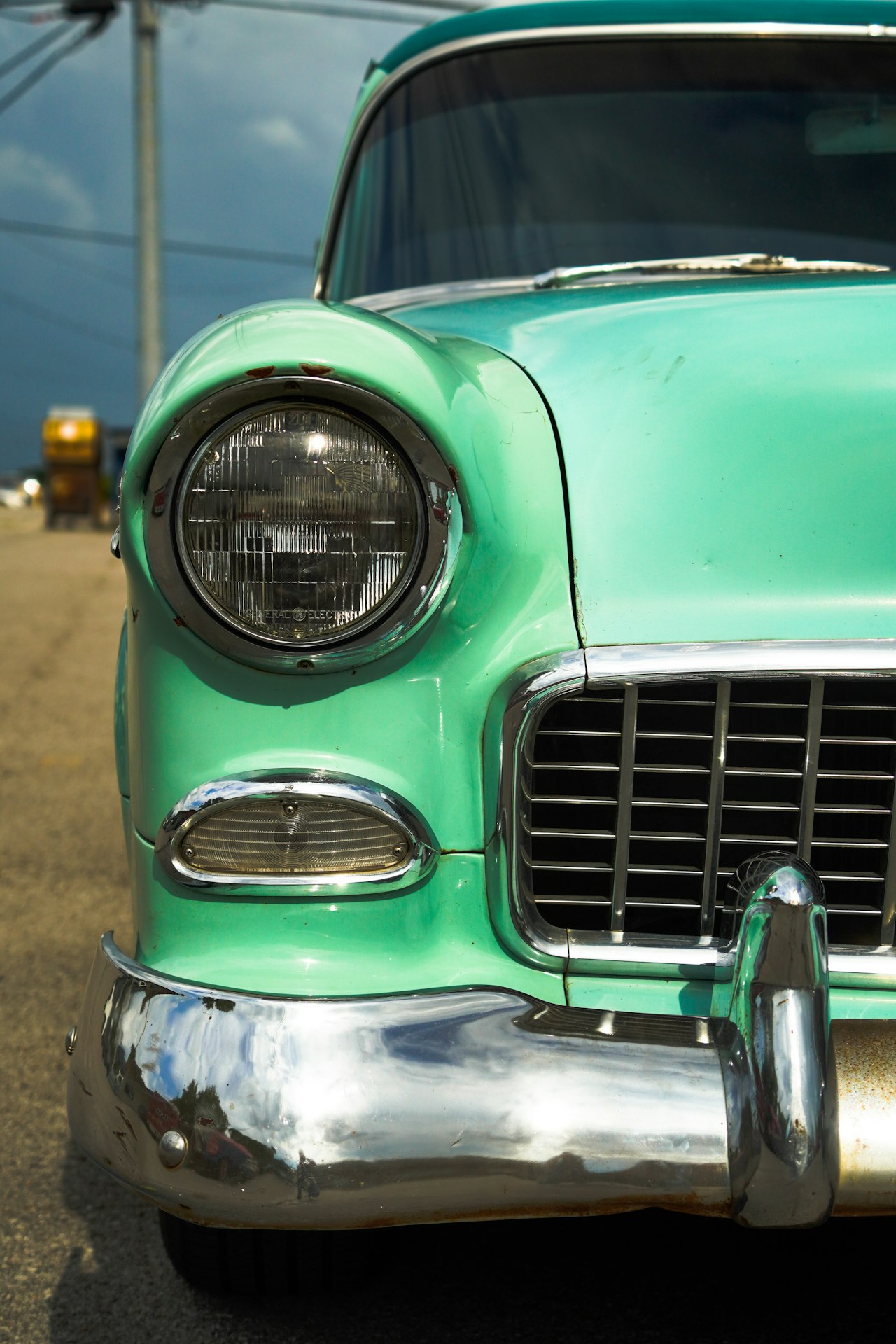 Front view of a turquoise classic car